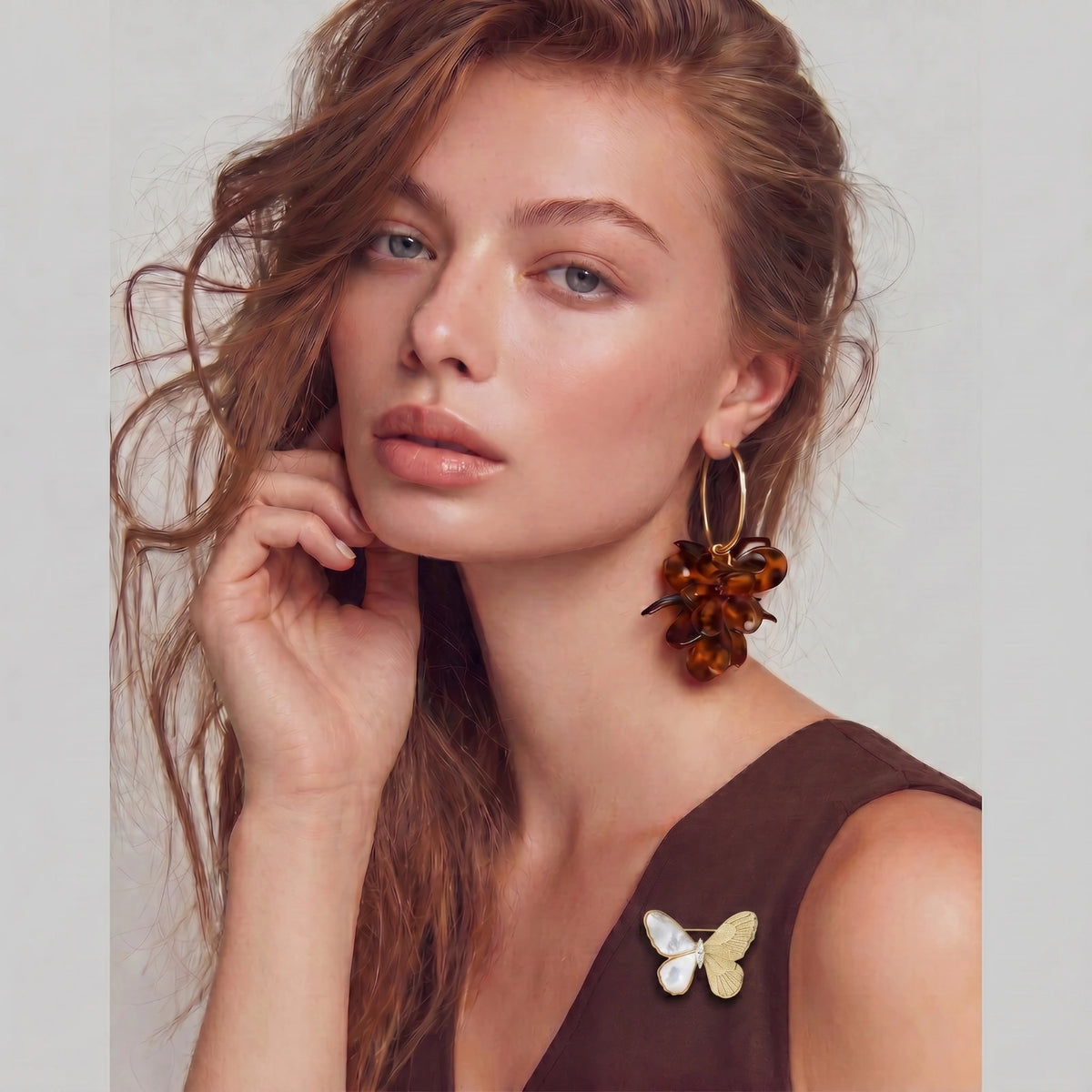 Ethereal Butterfly brooch worn on a sleeveless brown top.