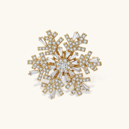 Winter Constellation snowflake brooch with gold-tone setting and clear zirconia crystals in a radiating pattern