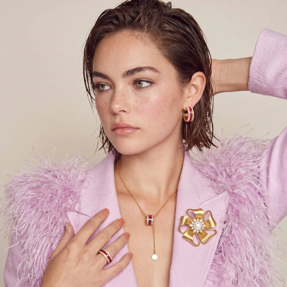 Close-up of the Gold Bloom flower brooch worn on a pale pink top.