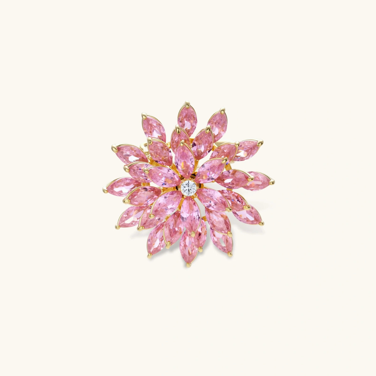 Bloom Burst Brooch with pink floral starburst design and sparkling stones on a white background