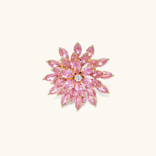 Bloom Burst Brooch with pink floral starburst design and sparkling stones on a white background